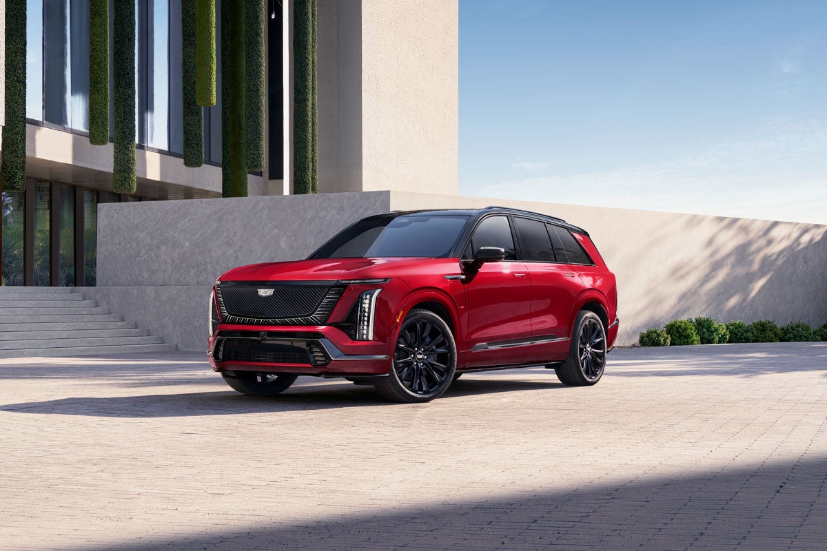Three-quarters View of a 2027 VISTIQ 3-row Electric SUV Parked near a Concrete Wall