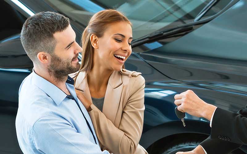 Happy couple getting car keys